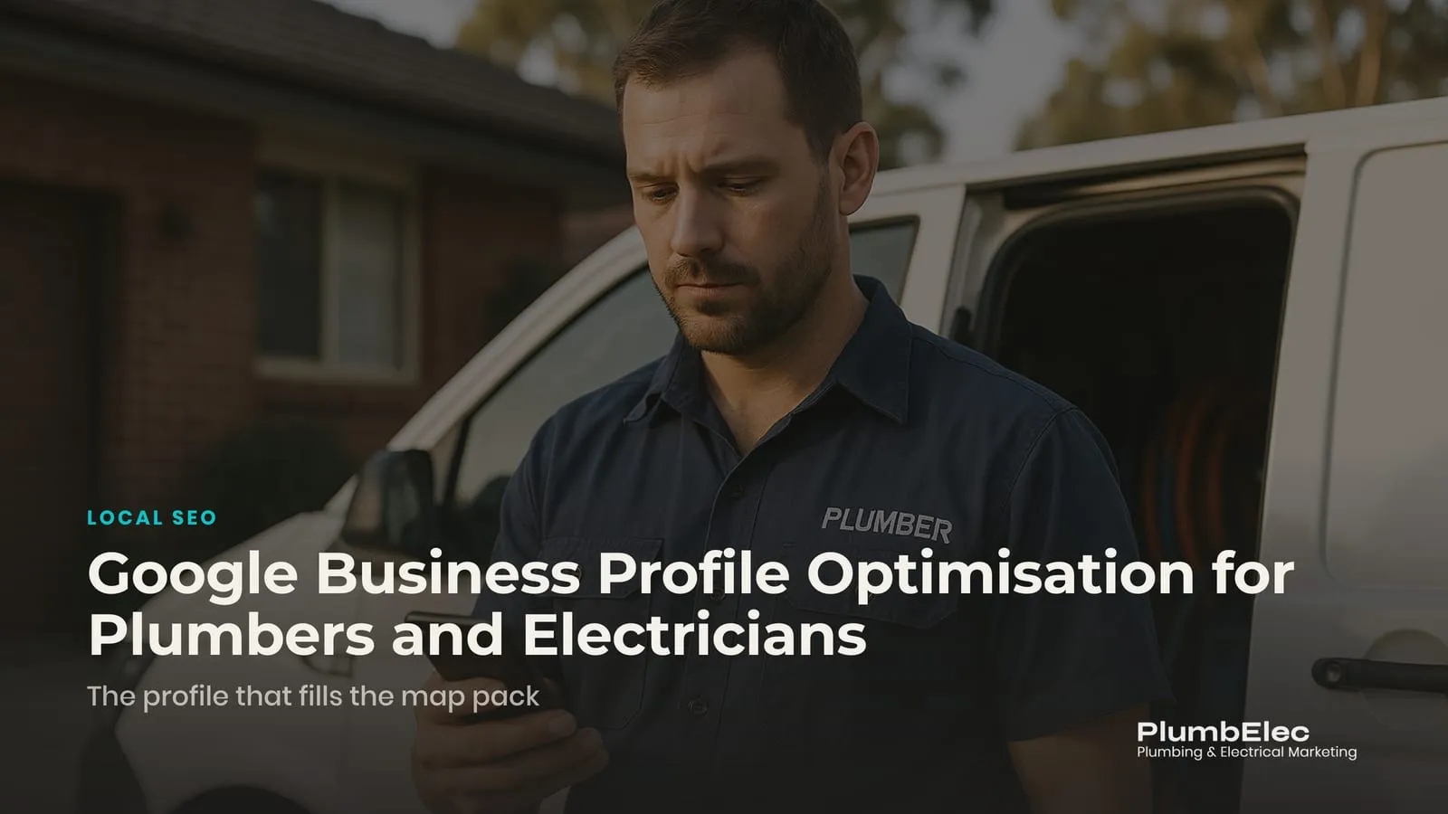 Plumber checking his Google Business Profile on a phone beside his work van in a Sydney driveway